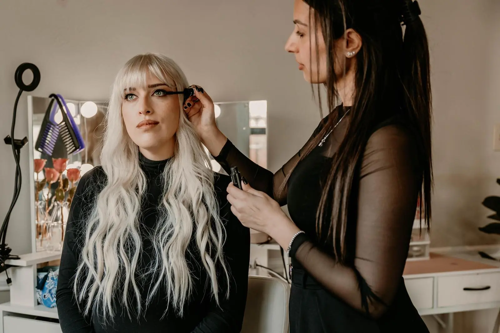 Sivan applying makeup to a client