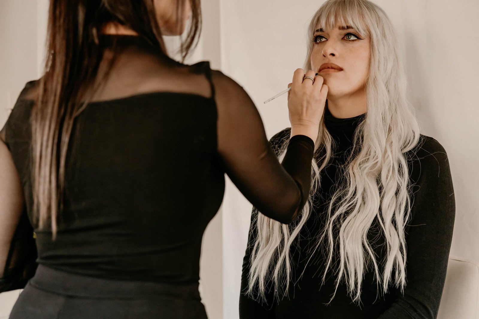 Sivan applying makeup to a client on-location across DFW